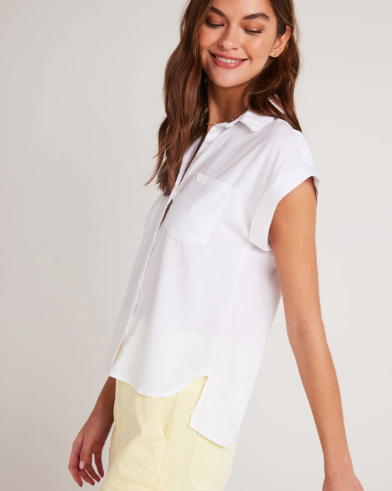 Woman smiling in a white button-down Bella Dahl Two Pocket S/S Shirt in White and yellow pants.