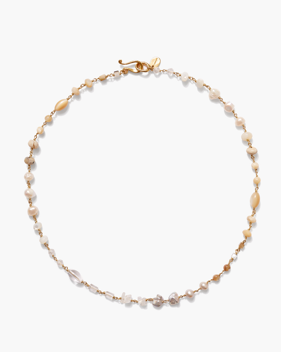 A delicate Chan Luu Daphne Beaded Necklace in White Mix, with interspersed golden beads and transparent crystals, displayed against a white background.