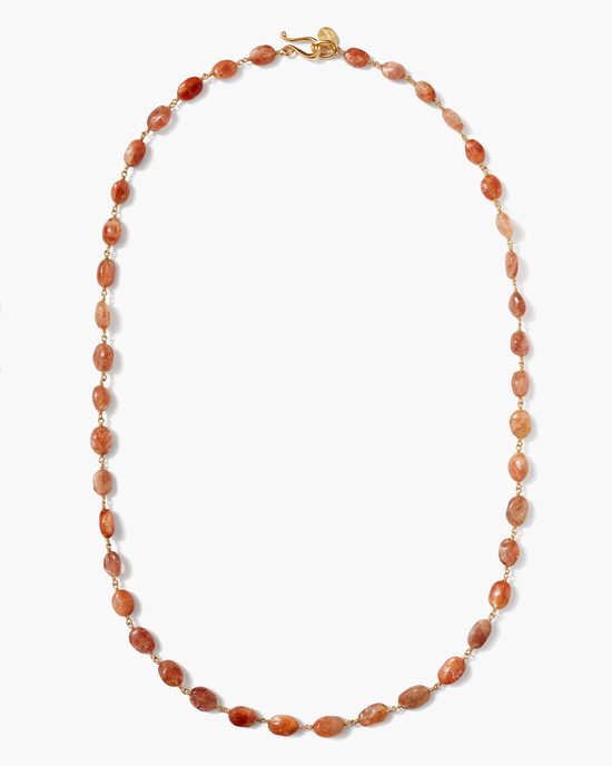 Amber beaded necklace with varying shades of orange and brown beads, featuring a gold clasp, displayed on a white background, styled as a Chan Luu Santa Fe Necklace in Sunstone.