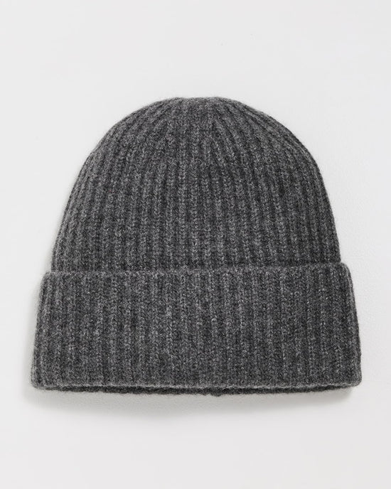 The Cashmere Plush Rib Beanie in Dark Slate Heather by White + Warren, featuring a ribbed cashmere knit and folded brim, is laid flat on a white surface.