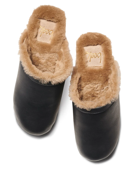 A pair of Woodpecker Mas Shearling slippers in Black/Bronze with genuine shearling lining and visible beek. labels on a white background.