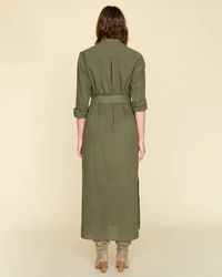 Woman facing away, wearing a long-sleeved XiRENA Hope Dress in Ash Green and boots.