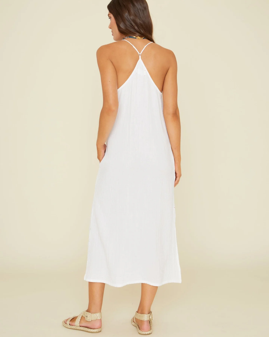 Woman in a XiRENA Talia Dress in White gauze halter-neck summer dress viewed from behind.