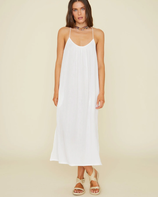 A woman wearing the XiRENA Talia Dress in White paired with sandals and a necklace.
