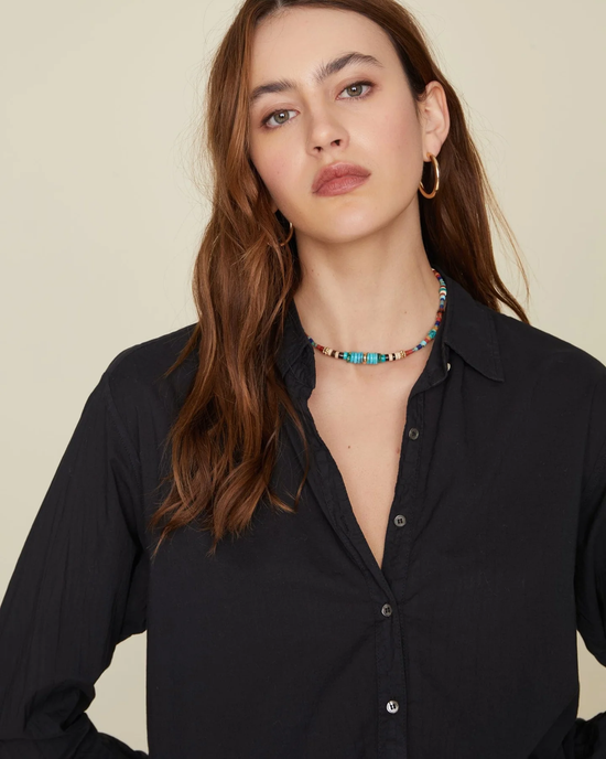 Woman wearing a XiRENA Black Beau Shirt and a colorful beaded necklace, made from Cotton Poplin in the USA.