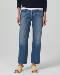 A person wearing Citizens of Humanity Emery Crop 27" in Oasis relaxed fit jeans and beige open-toe sandals.