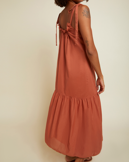 Woman wearing a Nation LTD Sequoia Voluminous Sundress in Tajin, sleeveless with a tie detail at the back.
