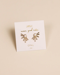 A pair of Sun Ray - White Opal design earrings with JaxKelly centers, presented on a branding card.