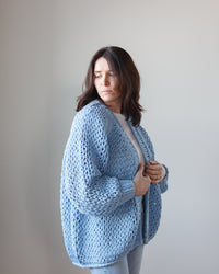 Woman in a Margaret O'Leary Placid Handknit Cardigan standing against a neutral background.