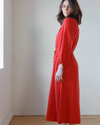 Woman in a Velvet by Graham & Spencer Audrey Dress in Cherry standing by a wall with eyes closed.