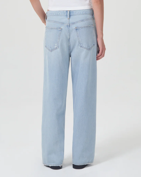 A woman wearing AGOLDE Low Slung Baggy in Shake jeans made from organic cotton.