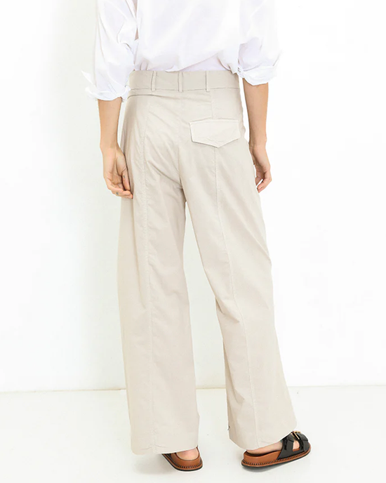 Person wearing beige straight-leg trousers and brown loafers with a white A Shirt Thing Marnie - Parachute in Sand tucked in.