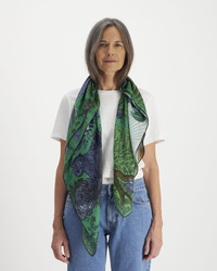 Mature woman in casual clothing with an oversized, Inoui Editions green printed Square 100 Reverie bandana.