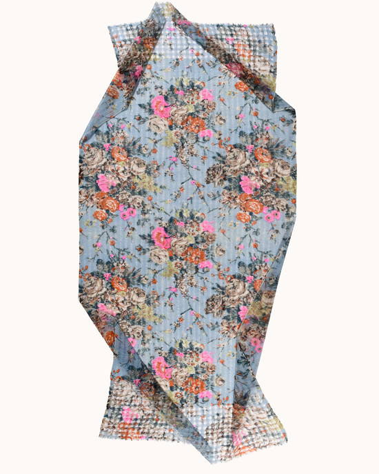 A Épice hand screen printed, floral patterned Fleur 1 Scarf in Sky with folded edges.