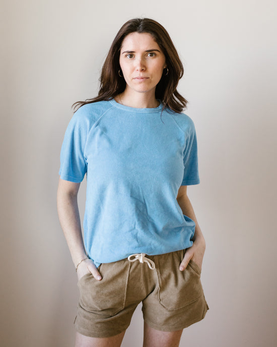 Woman standing in a slim fit Hartford Temery Shirt in Wave against a neutral background.