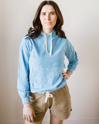 Woman in a Hartford Wave Towelling Tarol Hoody and beige shorts standing against a neutral background.