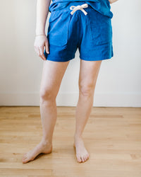 Person standing in blue Hartford Timoe Shorts in Mykonos with a drawstring waist against a plain background.