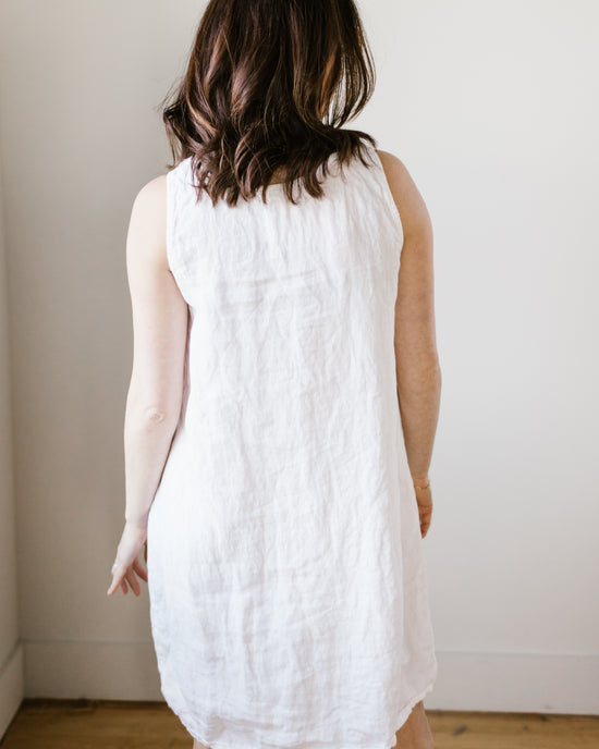 Woman standing with her back to the camera, wearing a Jess Dress in White HW Linen Twill by CP Shades against a plain background.