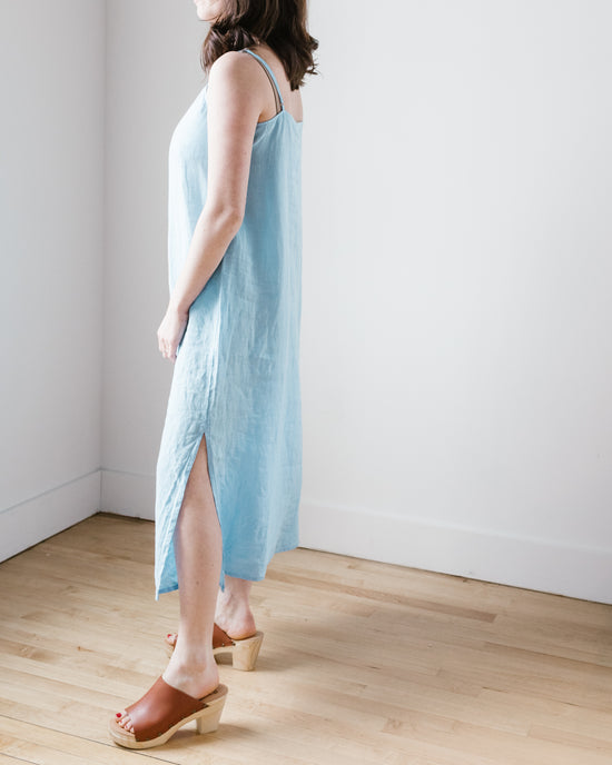 A person standing in a room wearing a Hartford Rubine Dress in Wave and tan platform sandals.