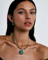 Woman showcasing a Chan Luu Daphne Beaded Necklace in Turquoise Mix and matching earrings with natural stones.