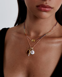 Woman wearing Chan Luu onyx beaded Merida Necklace in Multi Mix with pendants.
