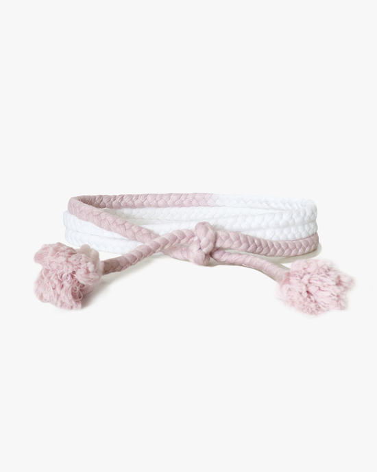 Pink and white ombre dip-dyed XiRENA Rope Belt in Rose Cloud with tassels on a white background.