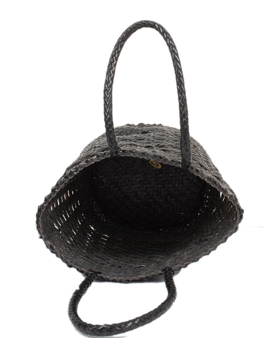 The Cannage Bucket - Big in Black by Dragon Diffusion is an open basket with two handles, showcasing a textured cannage weave interior.