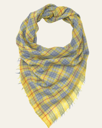 The No 623 Plaid Square Wool Scarf in Multicolor from Moismont displays a charming triangular drape, featuring fringe edges and a striking yellow and blue plaid pattern.