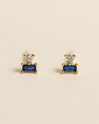 Gold earrings with a clear cubic zirconia stone set above a blue rectangular JaxKelly Sapphire Double Stack.