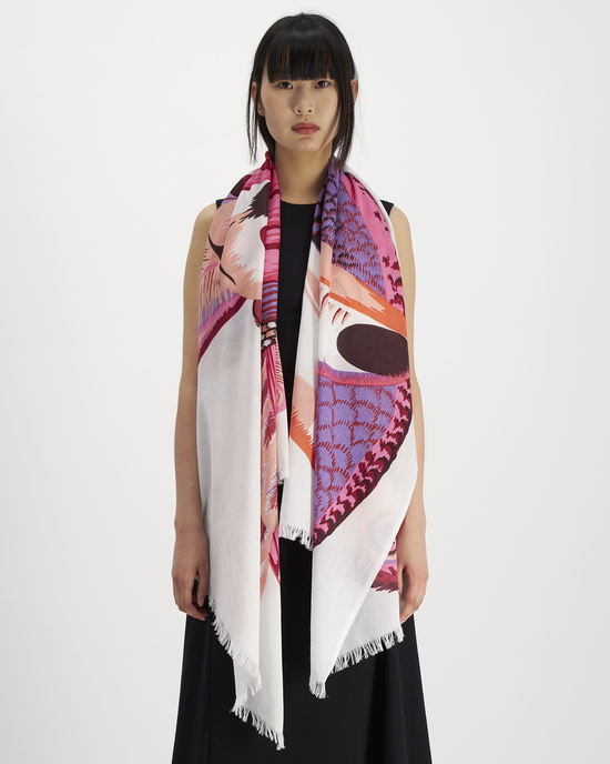 Woman posing with a Inoui Editions Scarf 100 Toucan in Pink over a black outfit against a white background.