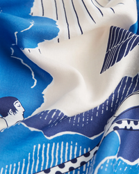 Close-up of an oversized Square 100 Yoga bandana crafted from a cotton/silk blend, featuring a graphic wave and human figure design on blue and white fabric by Inoui Editions.
