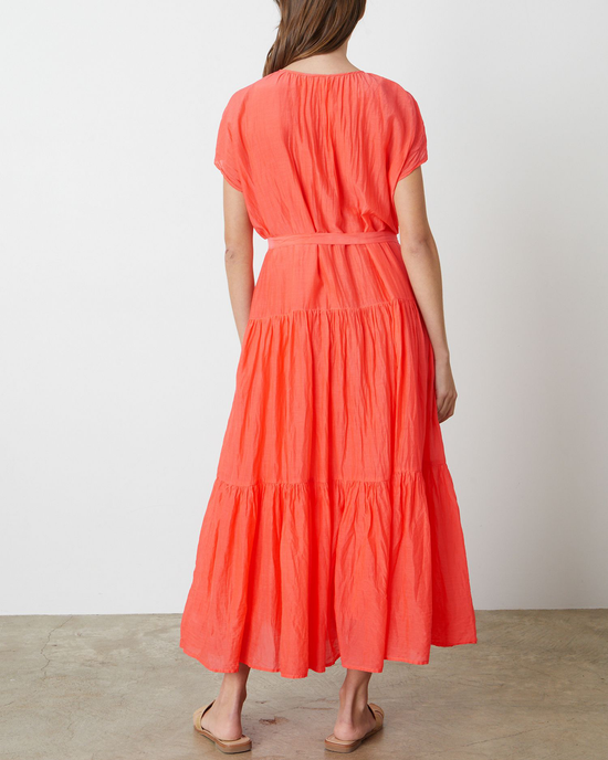 Woman standing with her back to the camera wearing a Velvet by Graham & Spencer Ada Flounce Tier Dress in Dolly.