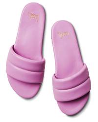 Pair of Sugarbird in Lilac slide sandals by beek. with a molded footbed isolated on a white background.